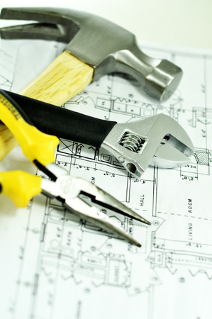 Hammer Wrench and Pliers on a Planの写真素材