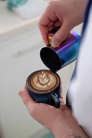 Barista Pouring Coffee with latte artの写真素材
