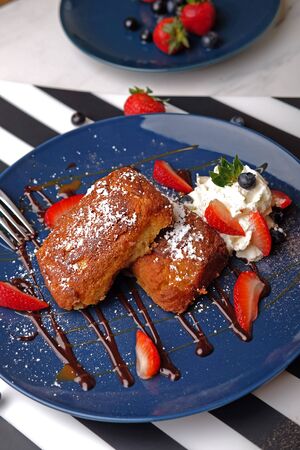 Pastry cake with strawberry and blueberry toppingsの写真素材