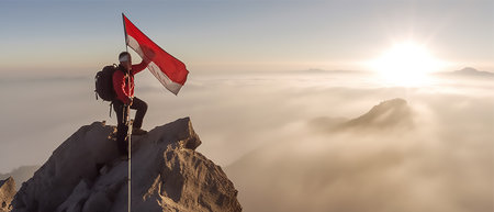 view of a climber raising the Indonesian red and white flag on a mountain with copy space background, generative aiの素材