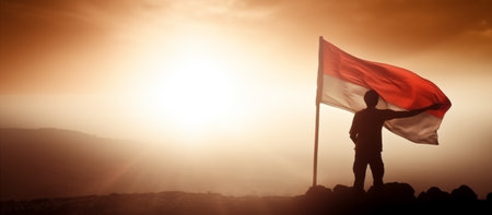 view of a climber raising the Indonesian red and white flag on a mountain with copy space background, generative aiの素材