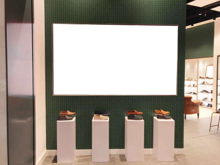 Large landscape light box digital signage in front of shoe retail store