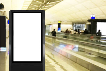 Blank advertisement billboard poster mock up at airport with long walkalator and blurred people as backgroundの写真素材