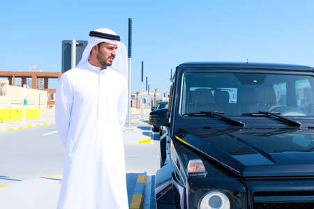Local Arab man beside a 4x4 vehicle