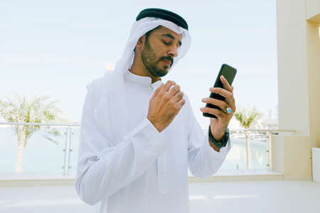 Middle Eastern Arab man using  mobile cell phone
