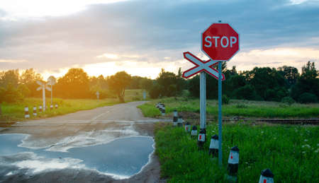 Old railway crossing in summer time in the evening