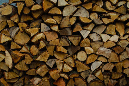 Wooden logs, beams, firewood, frame. A lot of wood. Wooden log wooden background. Fuel. Harvesting firewood for the winter. Loggingの写真素材
