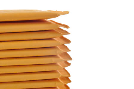 Stack of padded mailing envelopes isolated against a white backgroundの写真素材