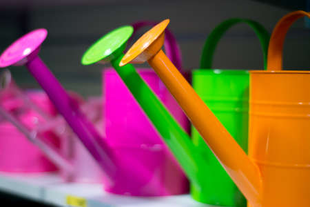 Metal watering cans for sale in a garden shopの写真素材