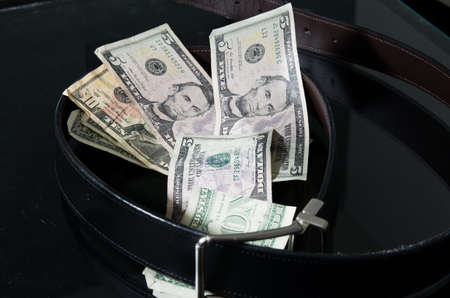 A belt cinching paper moneyの写真素材