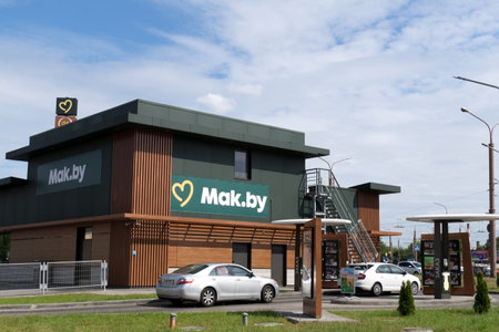 Grodno, Belarus - 06.13.2023: Hamburger fast food restaurant chain McDonald's in Belarus Mak.by. Cars at Mak.by drive thru service.のeditorial素材