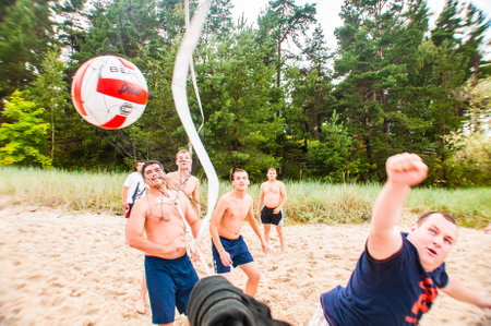 Jurmala, Latvia - August 20, 2011: Volleyball ball gets into the net. Beach volleyball game during the Baltic summer jewish seminar in Jurmala, Latvia.のeditorial素材