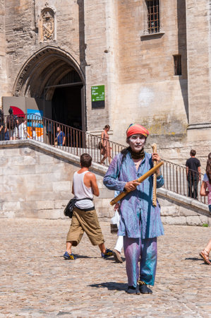 Avignon, France - July 23, 2011: Asian artist in traditional costume and music instrument performing in Old Town of Avignon, France during the Art Festival Off.のeditorial素材