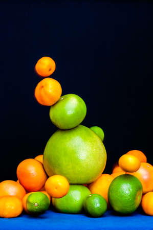 Falling tower of citruses, oranges, pomelo, limes, tangerines and grapefruitsの写真素材