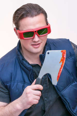 Portrait of young Caucasian Ethnicity man with red sunglasses holding bloody cleaver kitchen ax on...