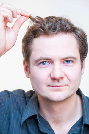 Portrait Of Young Caucasian Ethnicity Blue Eyed Man Points On His