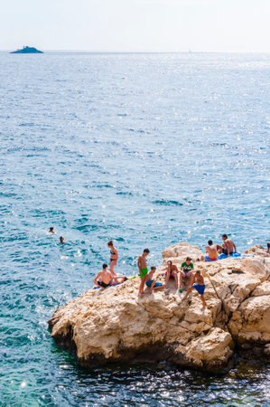 Rovinj, Croatia - June 18, 2014: Northern Croatia. Rocky beaches of Rovinj with crystal clear Adriatic Sea waters always full of people during the summer season.のeditorial素材