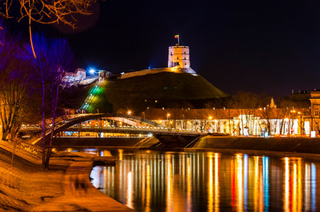 Vilnius, Lithuania - March 9, 2014. Night cityscape view of the Neris River, the Mindaugas' Bridge, the Old Town and the Gediminas' Tower that is the remaining part of the Upper Castle in Vilniusのeditorial素材