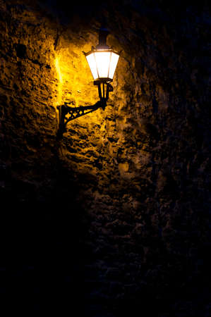 Wall lantern at night on the fortress wall in Tallinnの写真素材