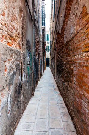 Super narrow street architecture in old town Venice Italyの写真素材