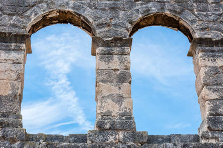 Sky view through the ancient Roman arch windows apertures