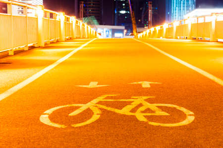 Night cityscape view of the White Bridge, the Lance sculpture, the downtown business buildings,...