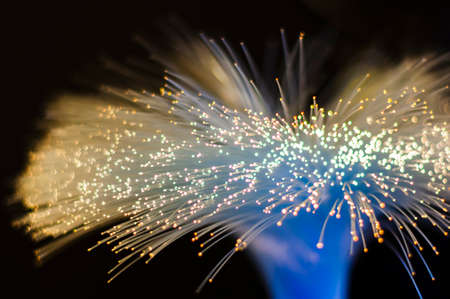 These series of images show twisted bundle of nylon fibers connected to light source and transmitting light.の写真素材