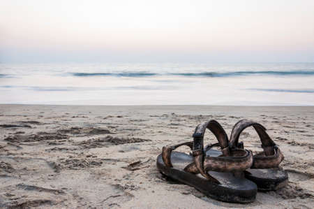 Long exposure shot of the sandals on the sand beach of Arabian sea at the sunset in Kochi.の写真素材