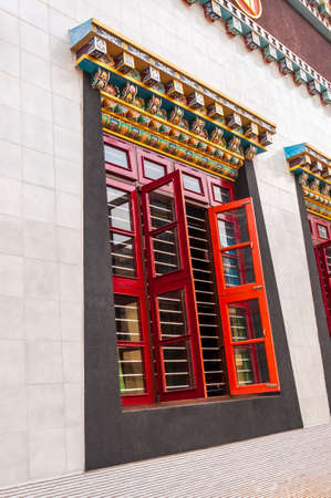 Bylakuppe, Karnataka, India: Tibetan window design art in the Namdroling Nyingmapa Monastery with vibrant cornice elements.の写真素材