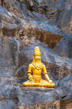 Murudeshwar, Karnataka, India: Golden sculpture of Vyasa the sage sitting and meditating on the rock...