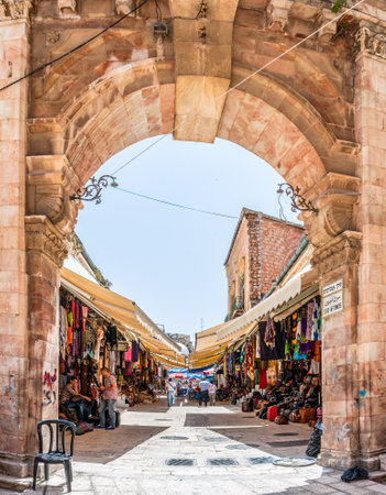 Jerusalem, Israel - May 25, 2012: Arch entrance to one of many alleys in ancient Old Town Market of Jerusalem full of shops with all kinds of touristic productsのeditorial素材