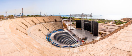 Caesarea, Israel - May 22, 2012: Panoramic view on ancient Caesarean amphitheater with modern scene prepared for the next show. Mediterranean sea on the background.のeditorial素材