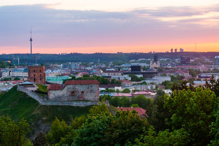 Vilnius, Lithuania - May 15, 2013: Cityscape skyline view on famous Gediminas castle complex and tv tower on the background from Three Crosses Hill panoramic viewpoint at sunsetのeditorial素材