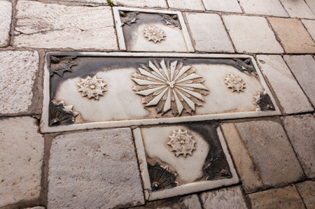 Skopje, Macedonia - June 10, 2013: Stone carving art example, abstract christian cross decor element on pavement, walkway in Old Town of Skopje, Macedoniaのeditorial素材