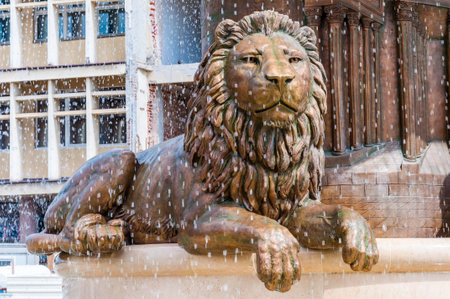 Skopje, Macedonia - June 10, 2013: Golden lion sculpture surrounded by falling fountain water streams as a part of the famous monument dedicated to ancient warrior king, Philip Second of Macedonのeditorial素材