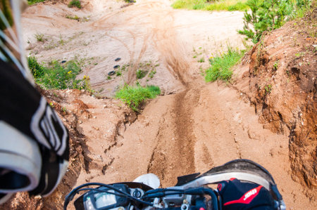 Vilnius, Lithuania - July 14, 2013: An amateur motorcyclists practice his manoeuvres with photographer sitting behind and making a shot of his track. This is an outdoors shot taken on public landのeditorial素材