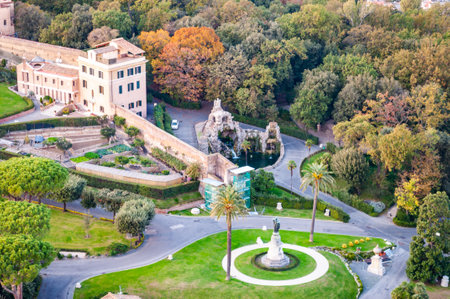 High view on cozy Vatican gardens with sculptures and fountains and museums buildings in Rome, Italyのeditorial素材