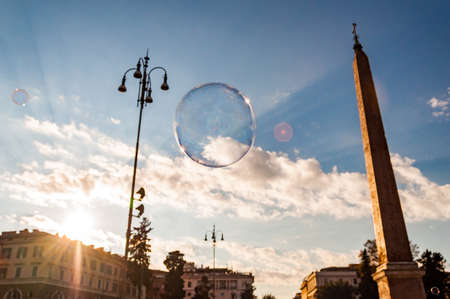 Light and colorful soap bubbles flying with the wind in the air to the sky above the Piazza del...