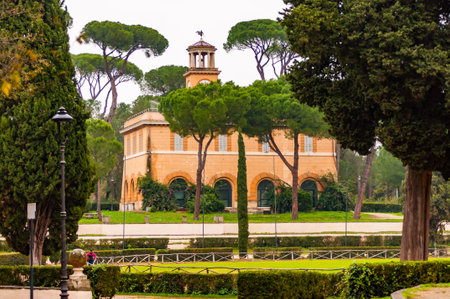 Rome, Italy - November 19, 2018: View through the park plants on Casino dell'Orologio, formerly was house of the gardener. Around 1791 was modified on a design by Antonio Asprucciのeditorial素材