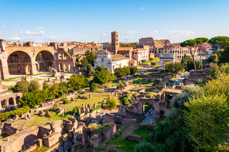 Rome, Italy - November 17, 2018: The Roman Forum, Forum Romanum surrounded by ruins of important ancient government buildings at the center of the city of Rome with Colosseum on backgroundのeditorial素材