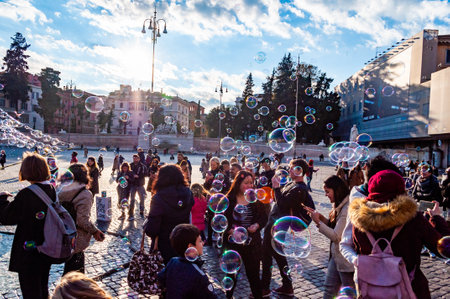 Rome, Italy - November 18, 2018: Soap bubbles flying on Piazza del Popolo, People Square in Rome full of happy positive people, tourists and locals with Roman architecture on backgroundのeditorial素材