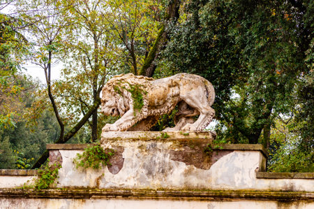 Rome, Italy - November 19, 2018: Ancient mossy overgrown lion stone sculpture statue in Borghese park on the way to the Villa Borgheseのeditorial素材