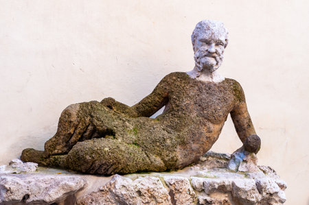 Rome, Italy - November 18, 2018: Outdoor sculpture of mossy overgrown man lying on the stone above the fountain in the front entrance of Canova Tadolini Museum in Rome, Italyのeditorial素材