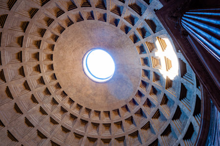 Rome, Italy - November 18, 2018: The famous cassette ceiling dome of Pantheon temple of all the gods with wide open rotunda on the top. Sunlight rays penetrating through oculus aperture on the roofのeditorial素材