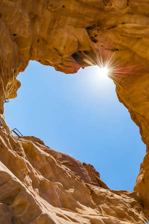 The Arches, amazing round hole in the rock, closed arch in ancient cooper mines canyons and mountains range in Timna National Park in Israelの写真素材