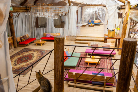 Eilat, Israel - March 21, 2017: Partly outdoor vibrant and colorful cozy interiors of an resting and bar areas full of shanti style chairs, couches, sofas in famous Dolphins beachのeditorial素材