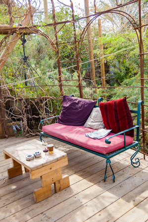 Eilat, Israel - March 21, 2017: Partly outdoor vibrant and colorful cozy interiors of an resting and bar areas full of shanti style chairs, couches, sofas in famous Dolphins beachのeditorial素材