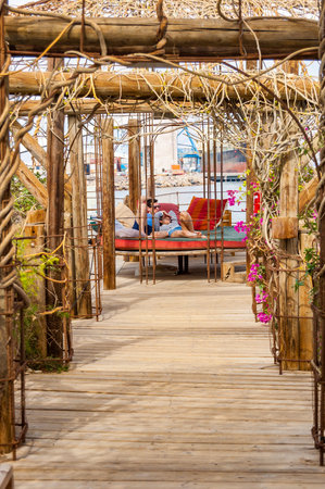 Eilat, Israel - March 21, 2017: On water pavilions and wooden walkways with resting inside couples in famous Dolphins beach in Eilat, Israelのeditorial素材