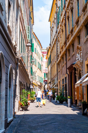 Sanremo, Italy - September 01, 2019: People walking by the narrow ancient medieval Old Town street in Sanremo, Italy.のeditorial素材