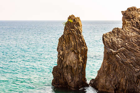 Two high rocks in the water on the beach of Monterosso Al Mare, Cinque Terre, Italy